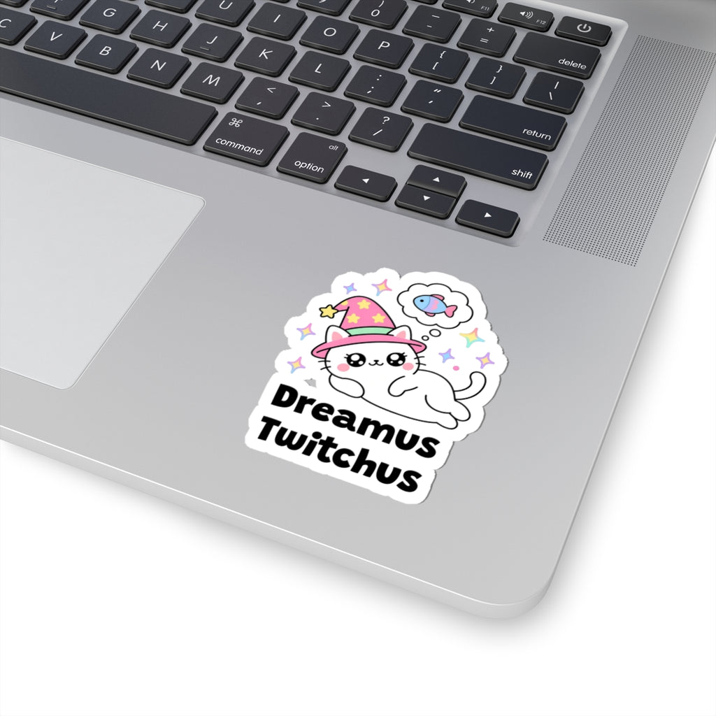 Dreamus Twitchus wizard cat sticker stuck on a silver laptop next to the keyboard