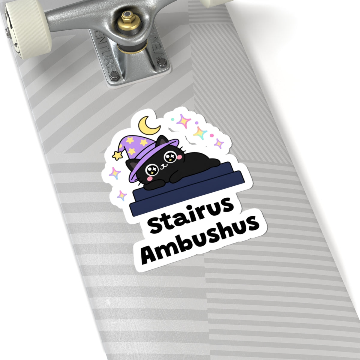 Stairus Ambushus wizard cat sticker on a grey skateboard deck near the truck