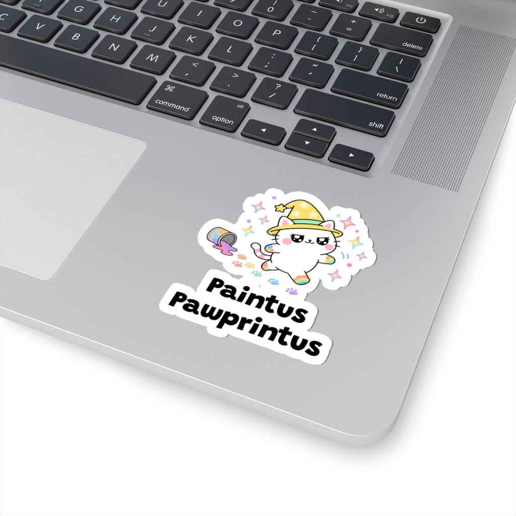 Paintus Pawprintus wizard cat sticker stuck on a silver laptop next to the keyboard