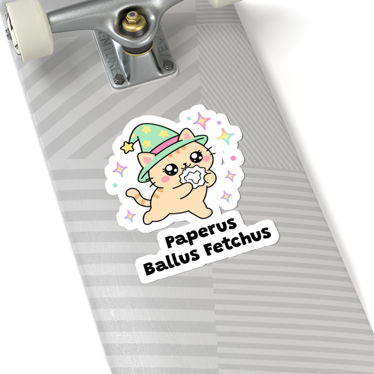 Paperus Ballus Fetchus wizard cat sticker on a grey skateboard deck near the truck