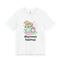 White Alarmus Felinus wizard cat T-shirt, front view: mint-green wizard cat in an orange hat on a pink pillow, pawing a ringing alarm clock, with "Alarmus Felinus" printed below