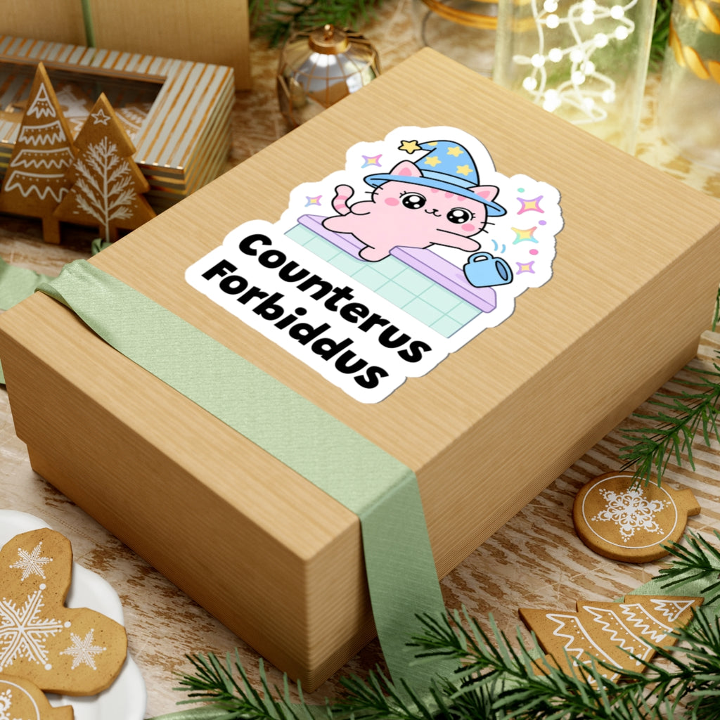 Counterus Forbiddus wizard cat sticker on a kraft gift box with a green ribbon and holiday cookies