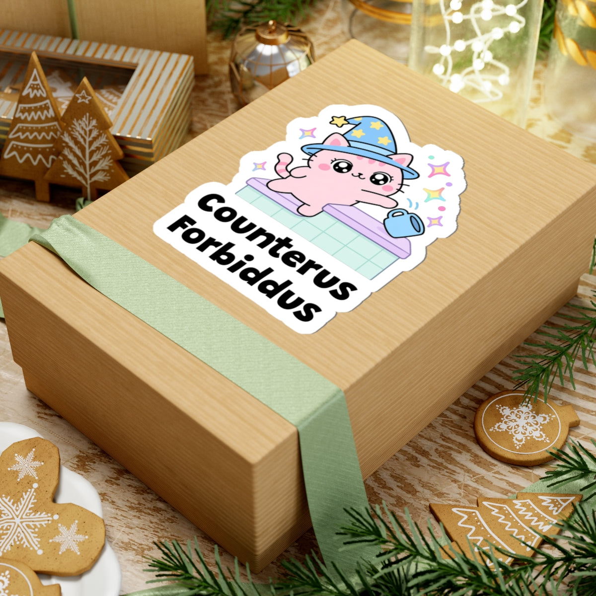 Counterus Forbiddus wizard cat sticker on a kraft gift box with a green ribbon and holiday cookies