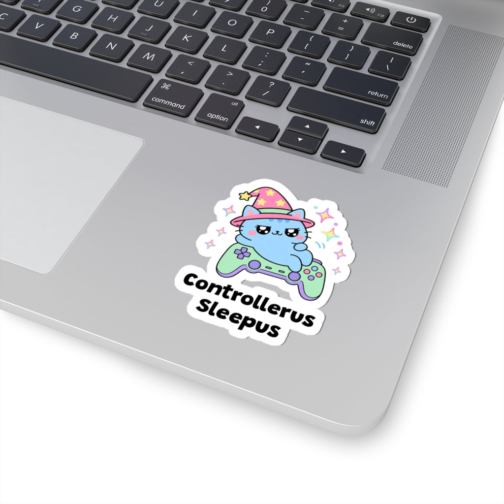 Controllerus Sleepus wizard cat sticker stuck on a silver laptop next to the keyboard
