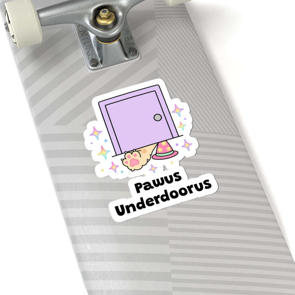 Pawus Underdoorus wizard cat sticker on a grey skateboard deck near the truck