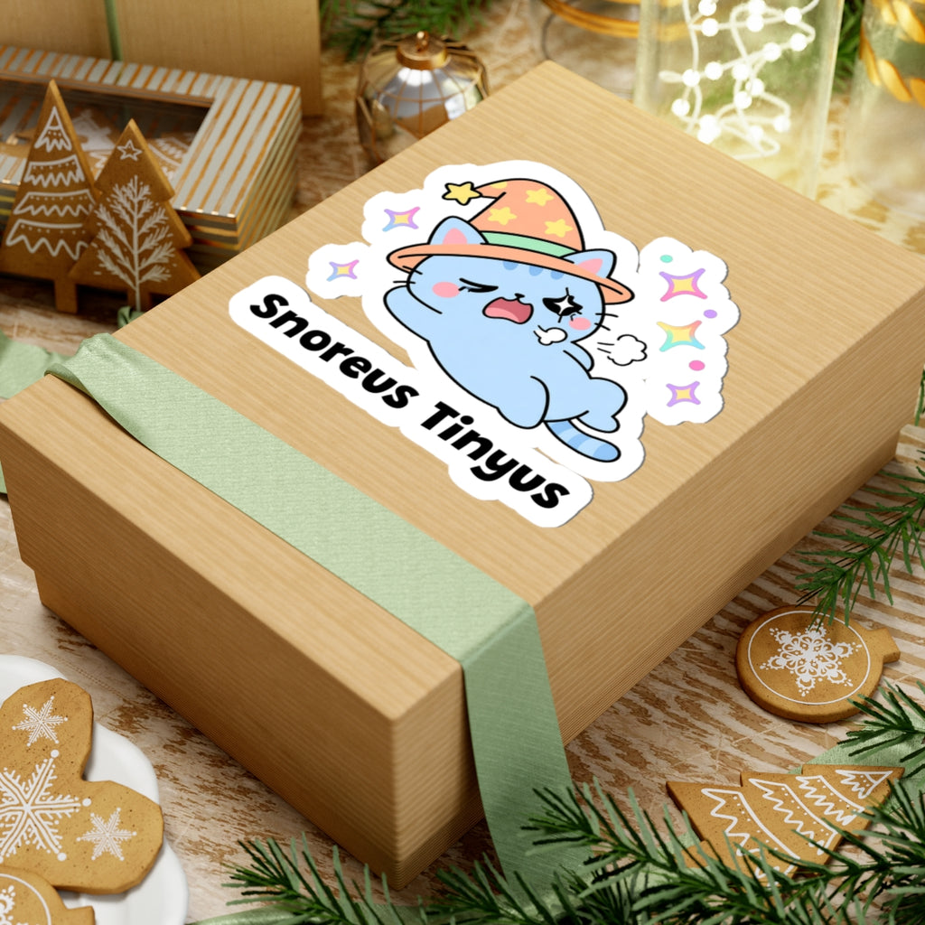 Snoreus Tinyus wizard cat sticker on a kraft gift box with a green ribbon and holiday cookies