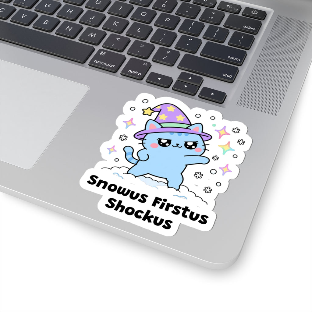 Snowus Firstus Shockus wizard cat sticker stuck on a silver laptop next to the keyboard