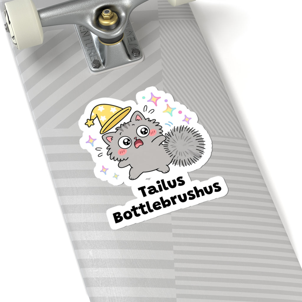 Tailus Bottlebrushus wizard cat sticker on a grey skateboard deck near the truck