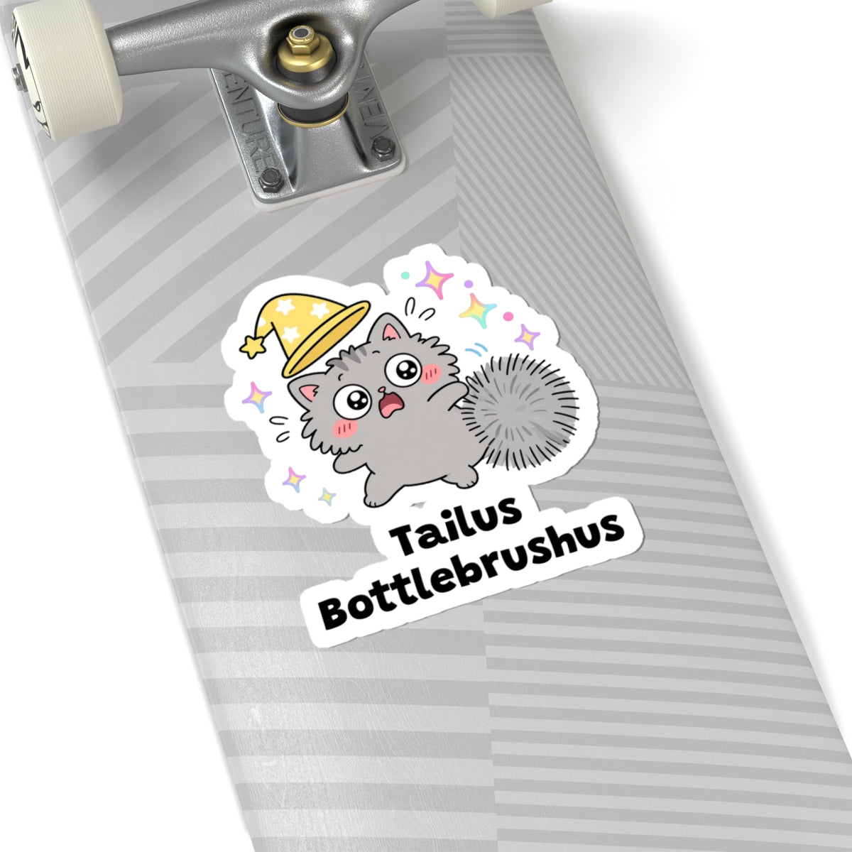 Tailus Bottlebrushus wizard cat sticker on a grey skateboard deck near the truck