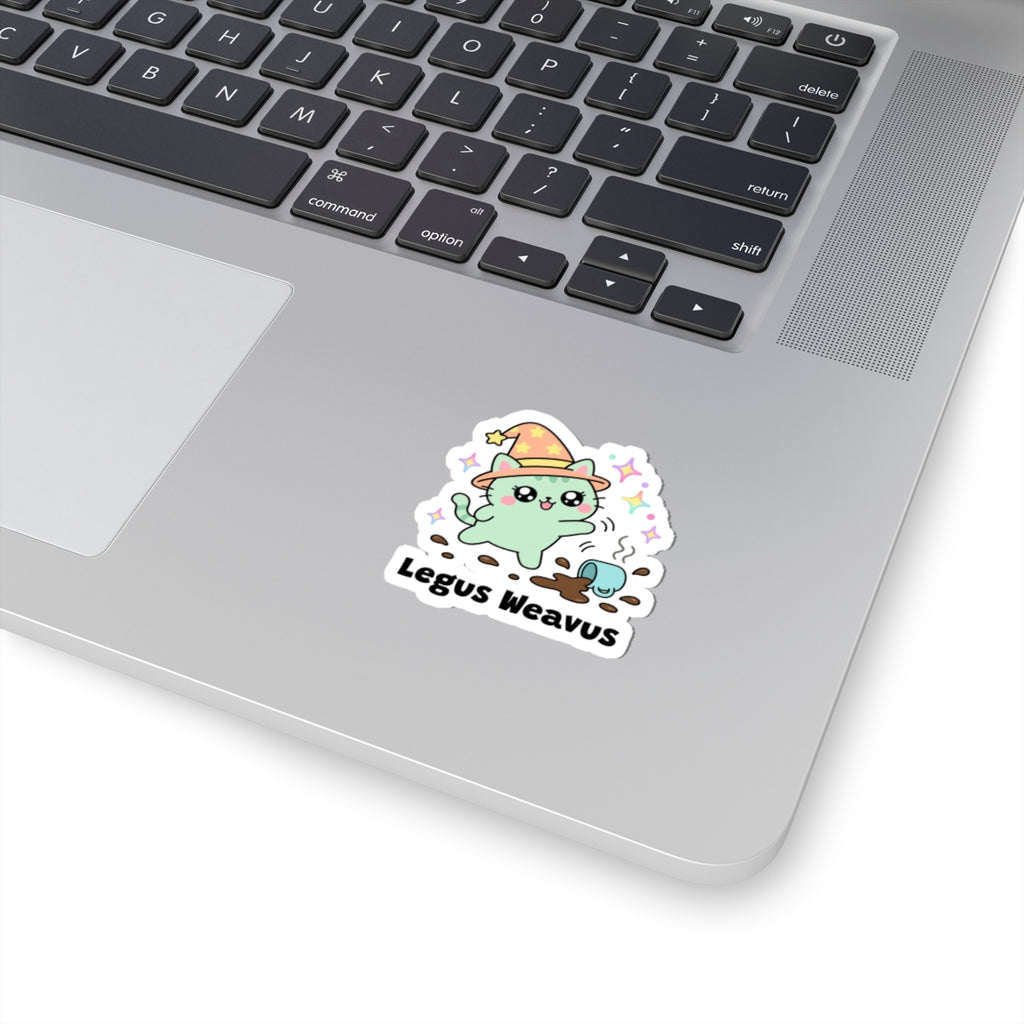 Legus Weavus wizard cat sticker stuck on a silver laptop next to the keyboard