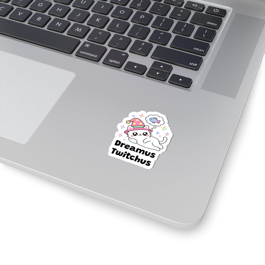 Dreamus Twitchus wizard cat sticker stuck on a silver laptop next to the keyboard