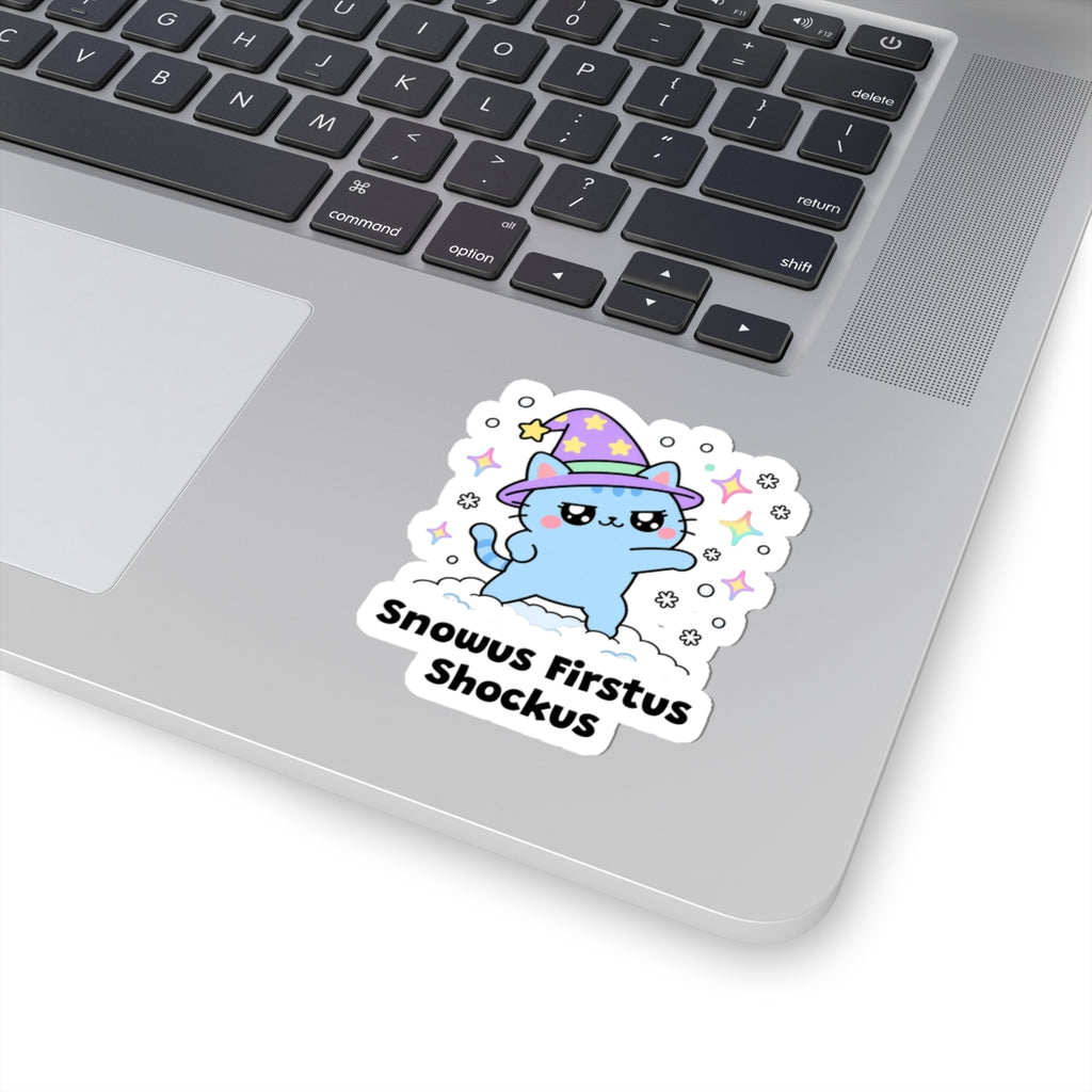 Snowus Firstus Shockus wizard cat sticker stuck on a silver laptop next to the keyboard