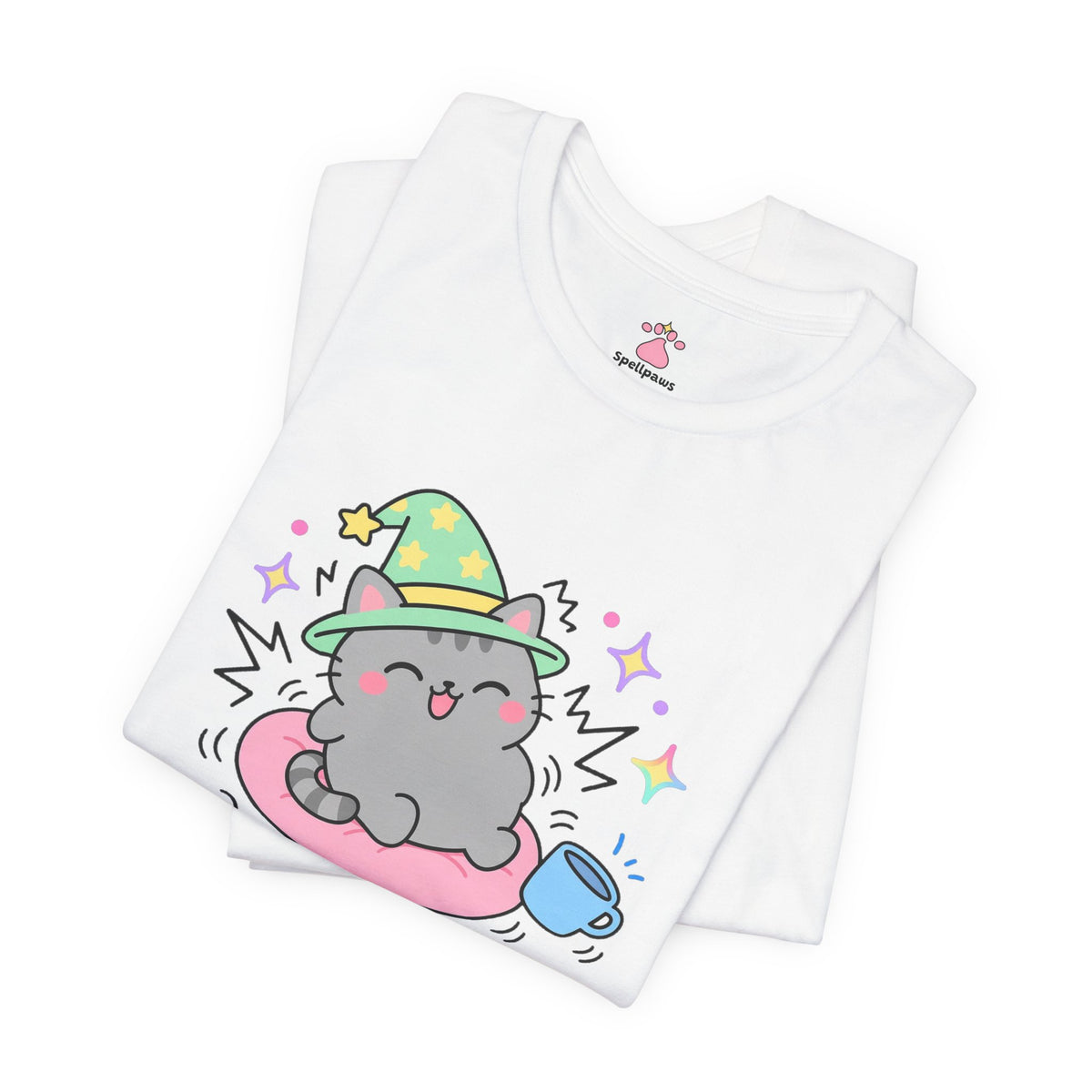 Folded white Purrus Engineus T-shirt showing a close-up of the grey tabby wizard cat in a green hat purring loudly on a pink cushion beside a mug