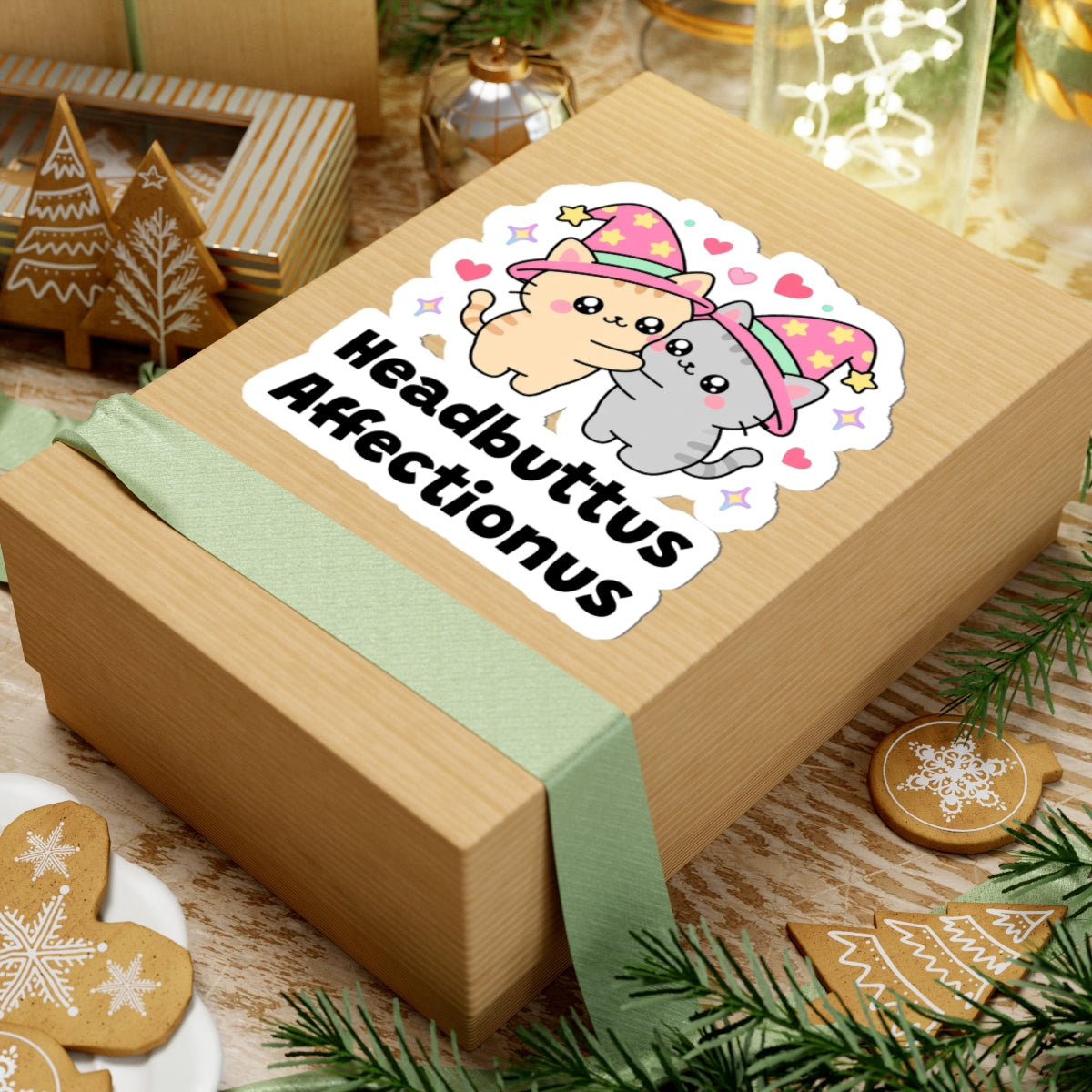 Headbuttus Affectionus wizard cat sticker on a kraft gift box with a green ribbon and holiday cookies