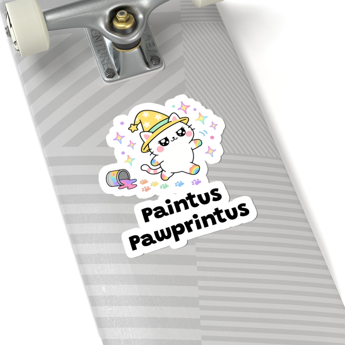 Paintus Pawprintus wizard cat sticker on a grey skateboard deck near the truck