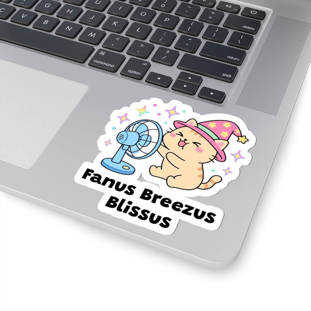 Fanus Breezus Blissus wizard cat sticker stuck on a silver laptop next to the keyboard