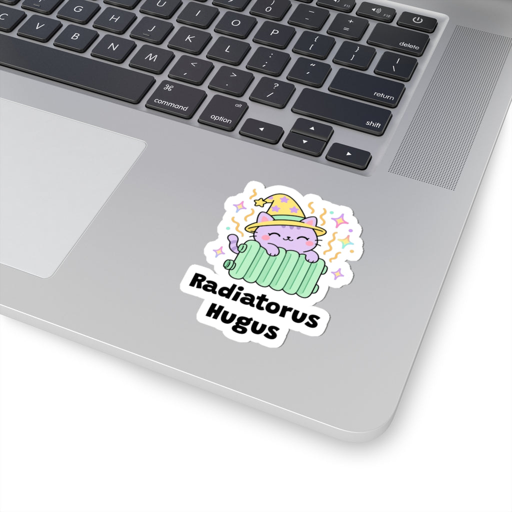 Radiatorus Hugus wizard cat sticker stuck on a silver laptop next to the keyboard