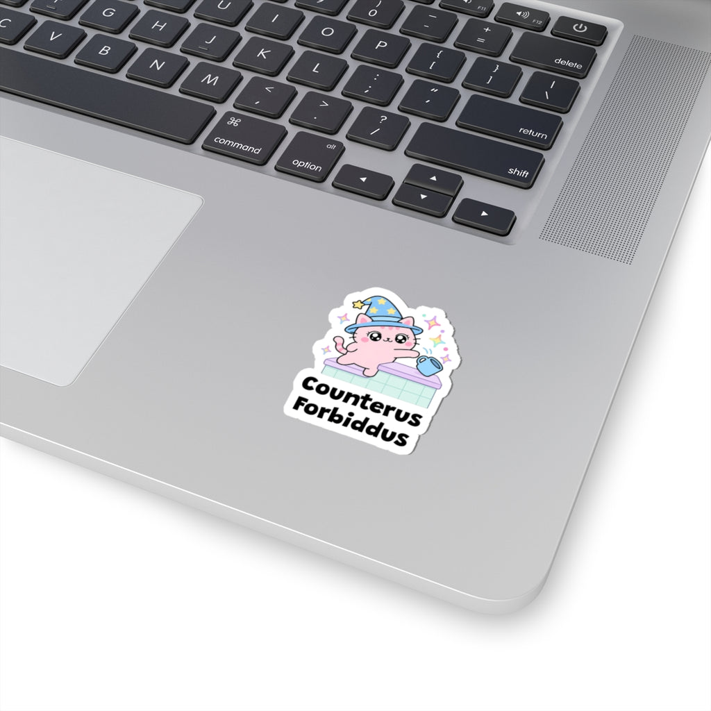 Counterus Forbiddus wizard cat sticker stuck on a silver laptop next to the keyboard