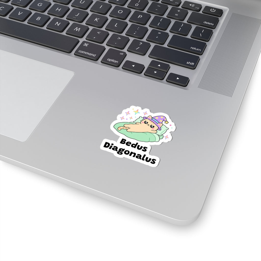 Bedus Diagonalus wizard cat sticker stuck on a silver laptop next to the keyboard