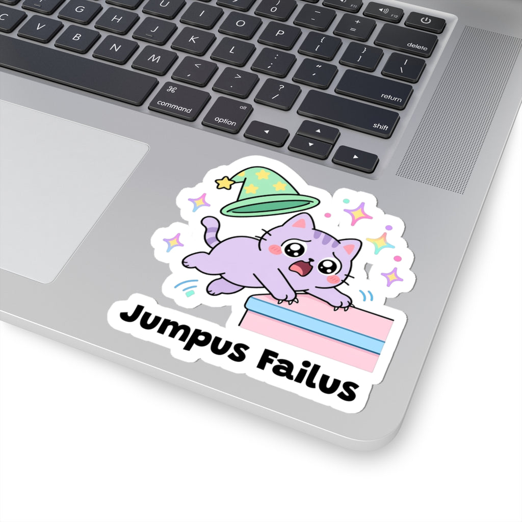 Jumpus Failus wizard cat sticker stuck on a silver laptop next to the keyboard