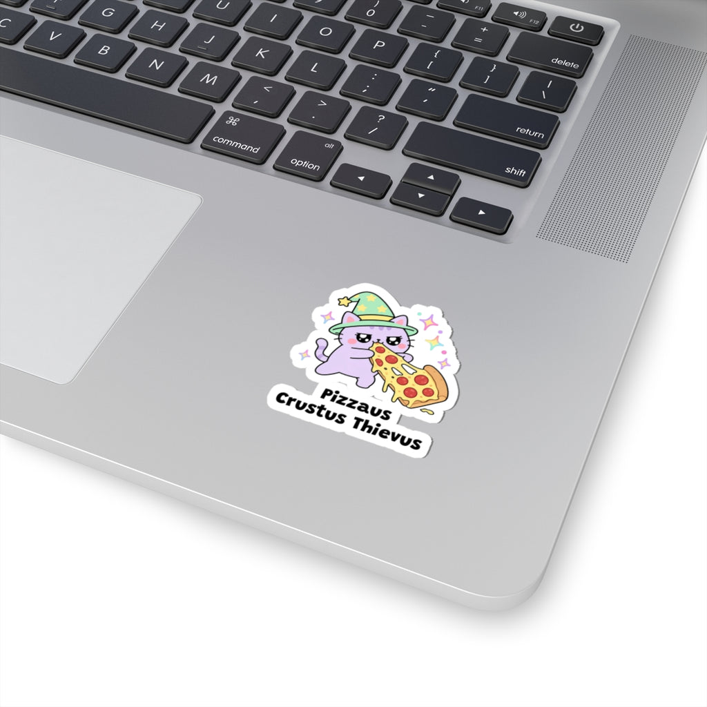 Pizzaus Crustus Thievus wizard cat sticker stuck on a silver laptop next to the keyboard