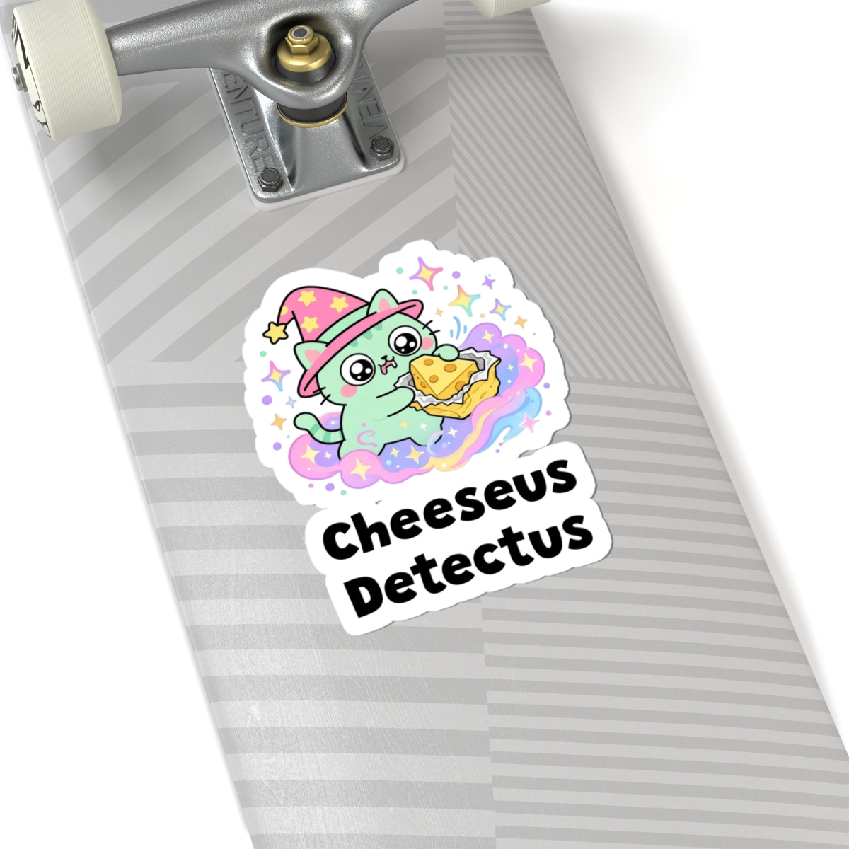 Cheeseus Detectus wizard cat sticker on a grey skateboard deck near the truck