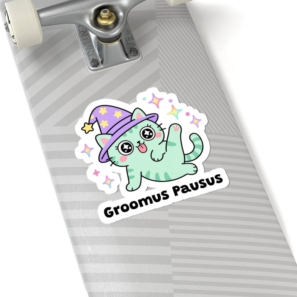 Groomus Pausus wizard cat sticker on a grey skateboard deck near the truck