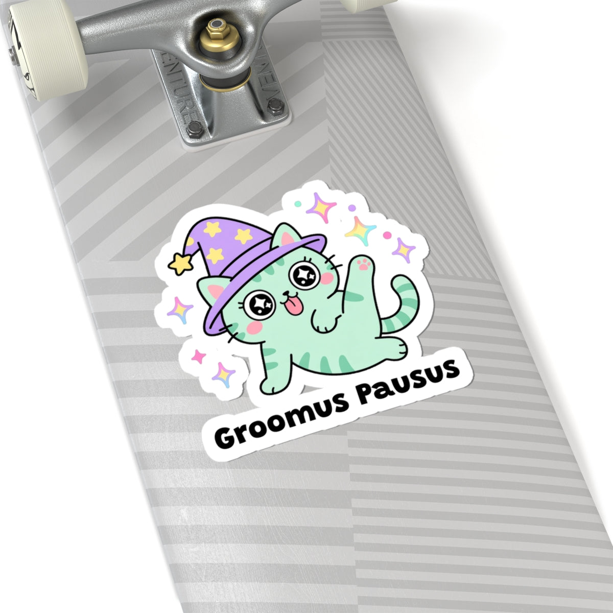 Groomus Pausus wizard cat sticker on a grey skateboard deck near the truck