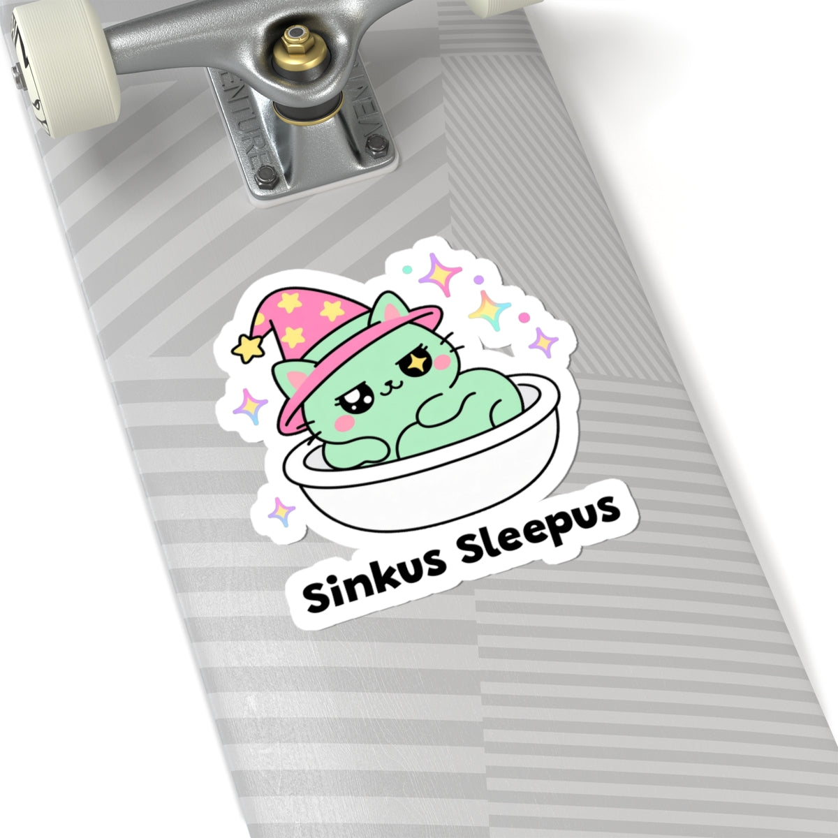 Sinkus Sleepus wizard cat sticker on a grey skateboard deck near the truck