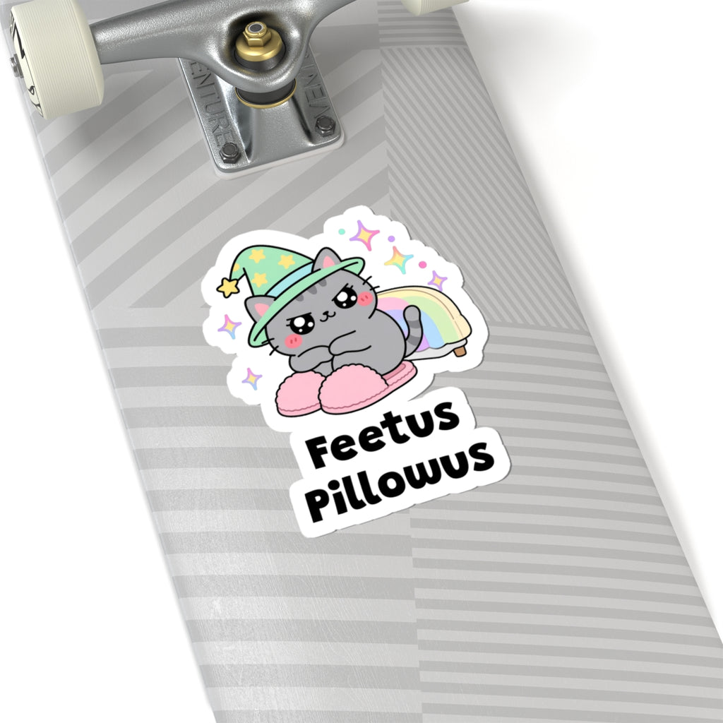 Feetus Pillowus wizard cat sticker on a grey skateboard deck near the truck