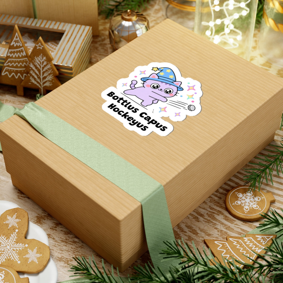 Bottlus Capus Hockeyus wizard cat sticker on a kraft gift box with a green ribbon and holiday cookies
