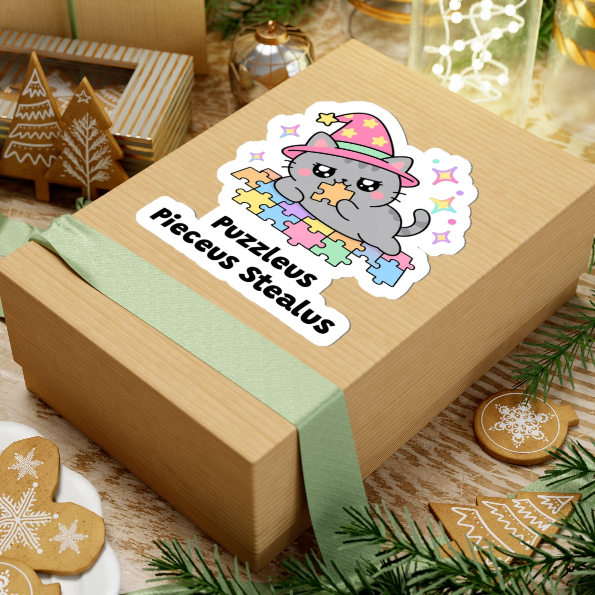 Puzzleus Pieceus Stealus wizard cat sticker on a kraft gift box with a green ribbon and holiday cookies