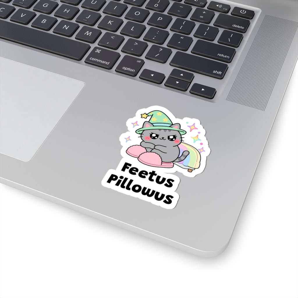 Feetus Pillowus wizard cat sticker stuck on a silver laptop next to the keyboard