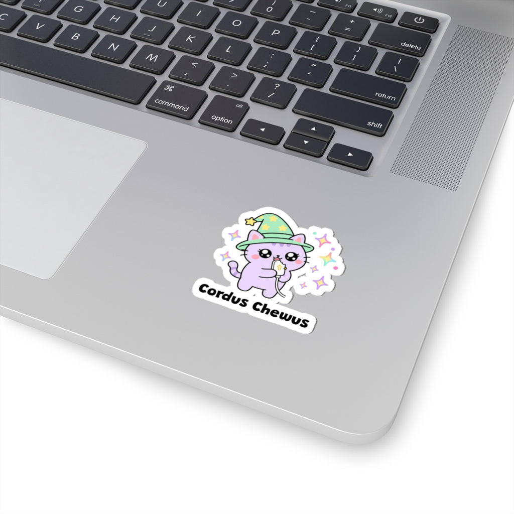 Cordus Chewus wizard cat sticker stuck on a silver laptop next to the keyboard