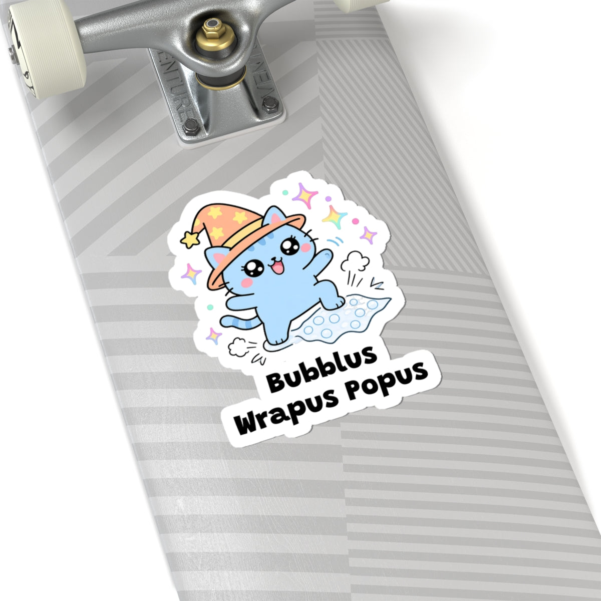 Bubblus Wrapus Popus wizard cat sticker on a grey skateboard deck near the truck