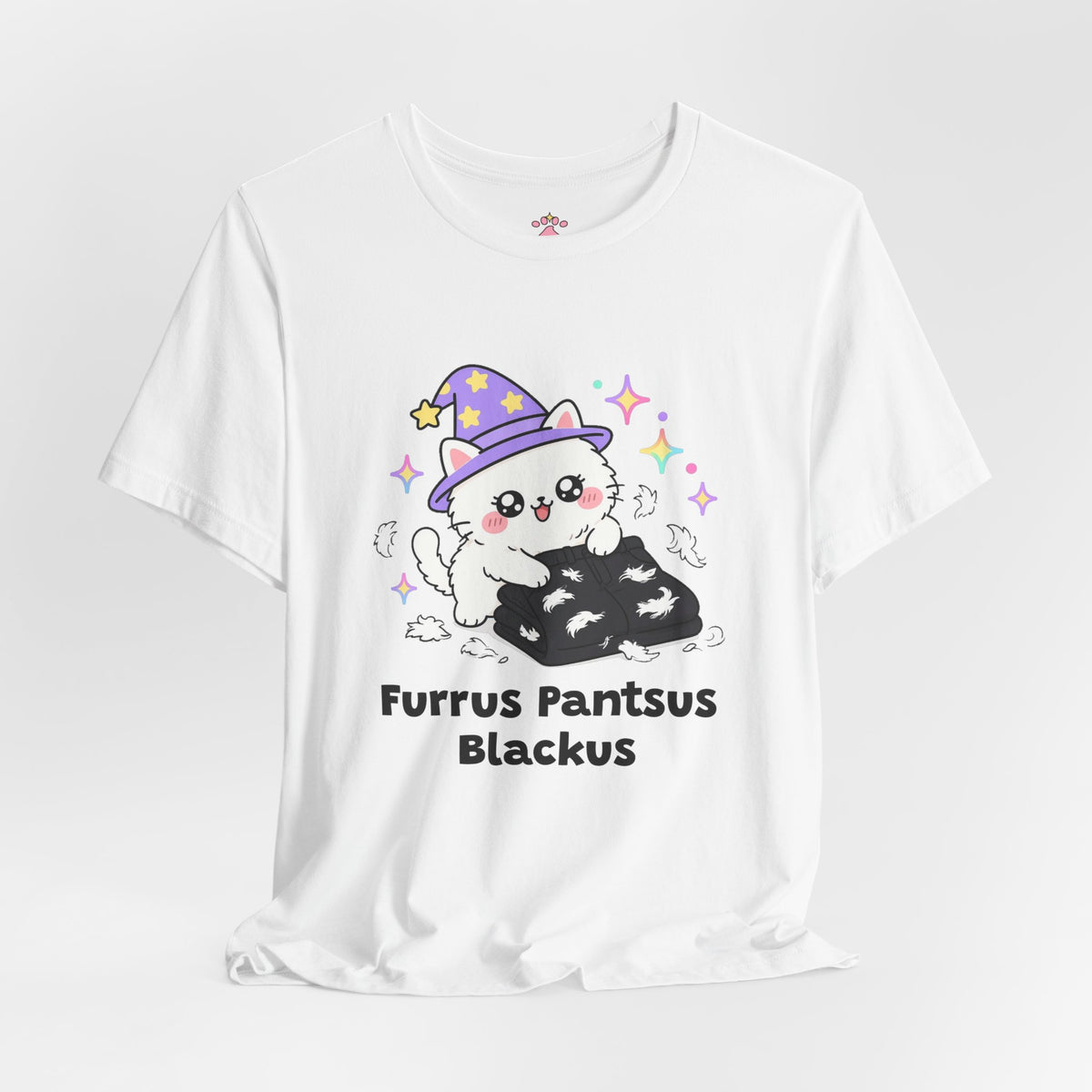 White Furrus Pantsus Blackus wizard cat T-shirt shown in a soft studio setting: fluffy white wizard cat in a purple hat lying on a pair of black pants covered in fur