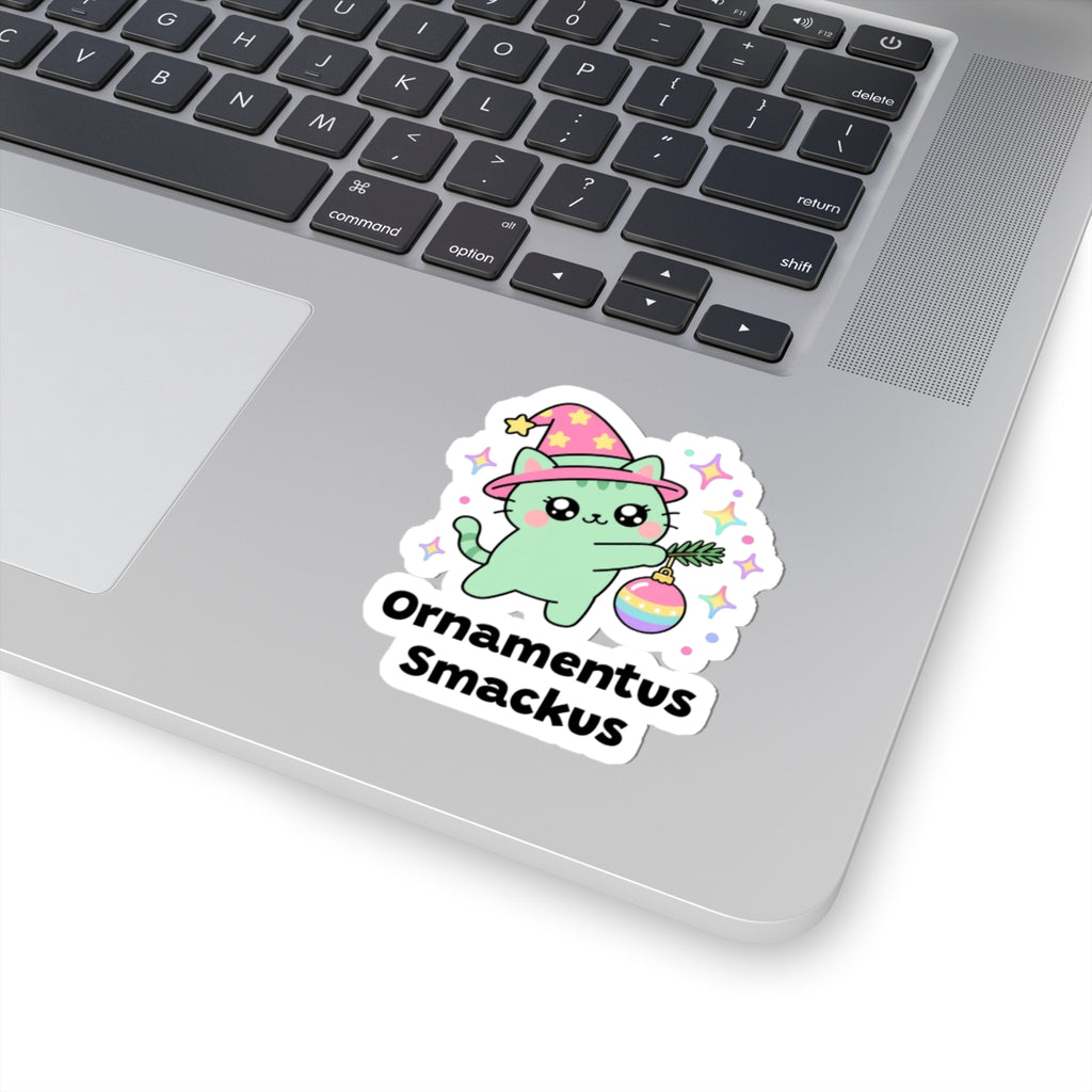 Ornamentus Smackus wizard cat sticker stuck on a silver laptop next to the keyboard