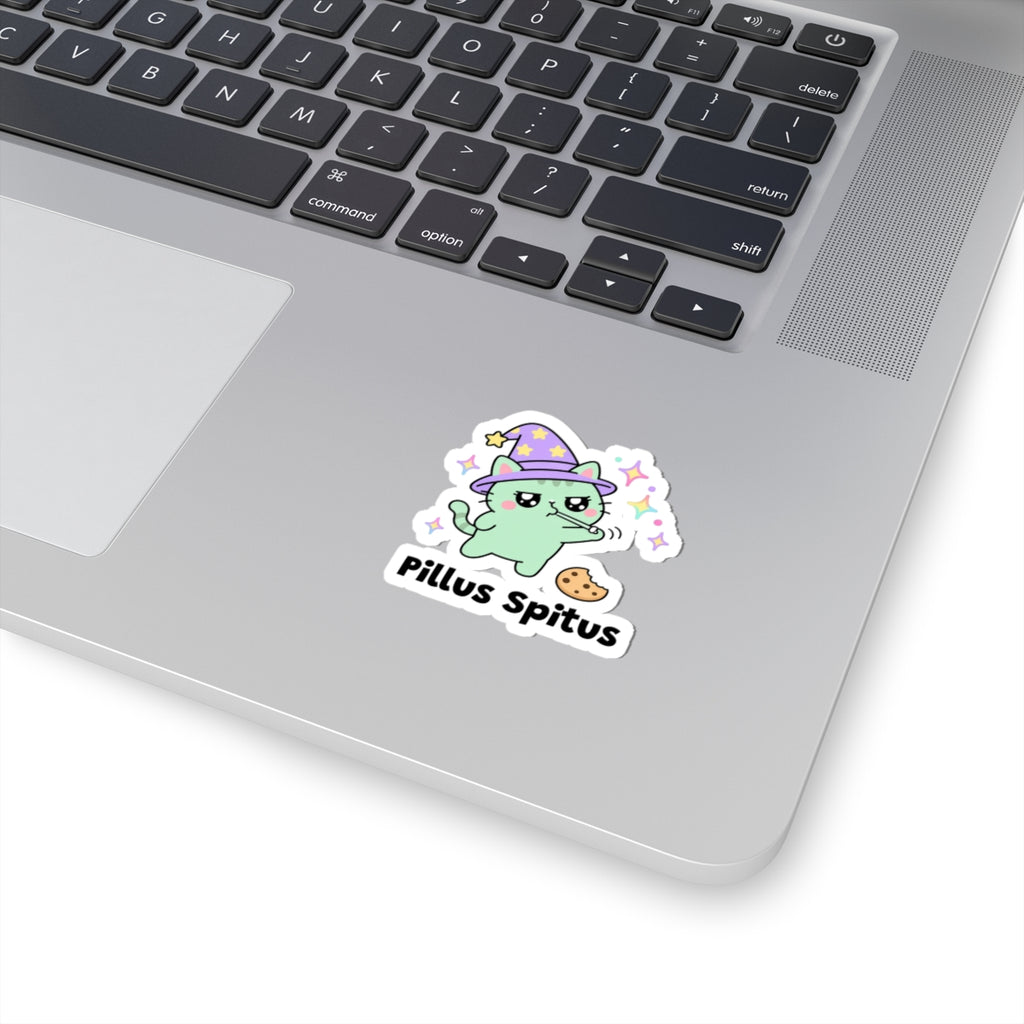Pillus Spitus wizard cat sticker stuck on a silver laptop next to the keyboard
