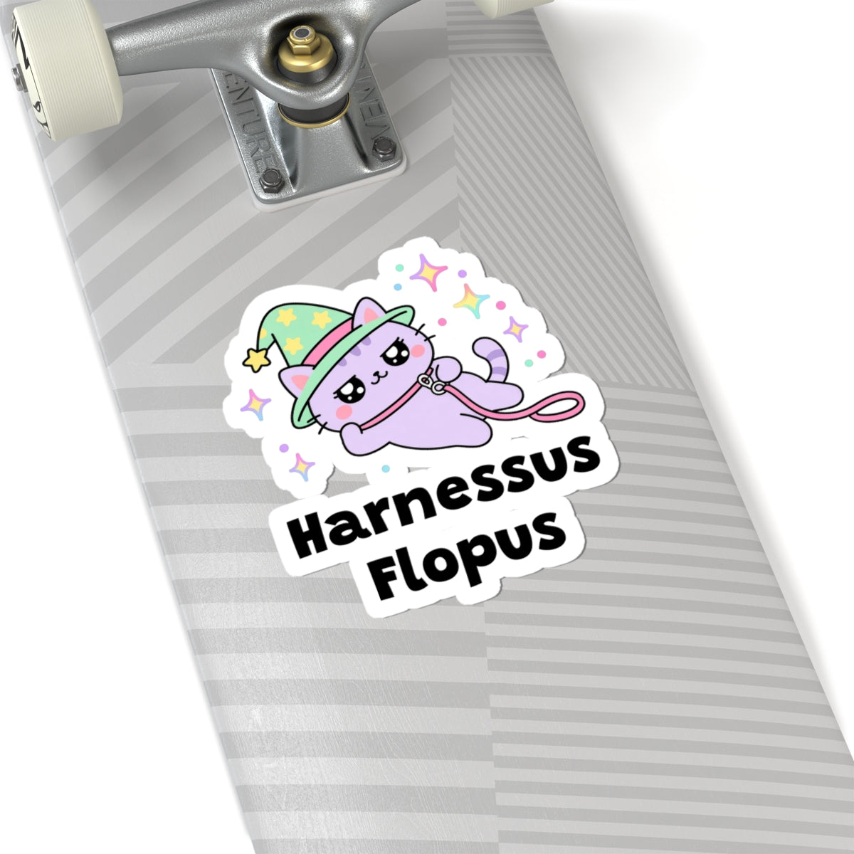 Harnessus Flopus wizard cat sticker on a grey skateboard deck near the truck