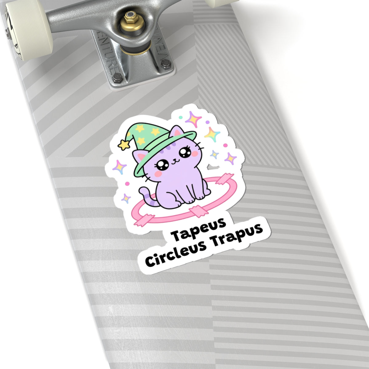 Tapeus Circleus Trapus wizard cat sticker on a grey skateboard deck near the truck
