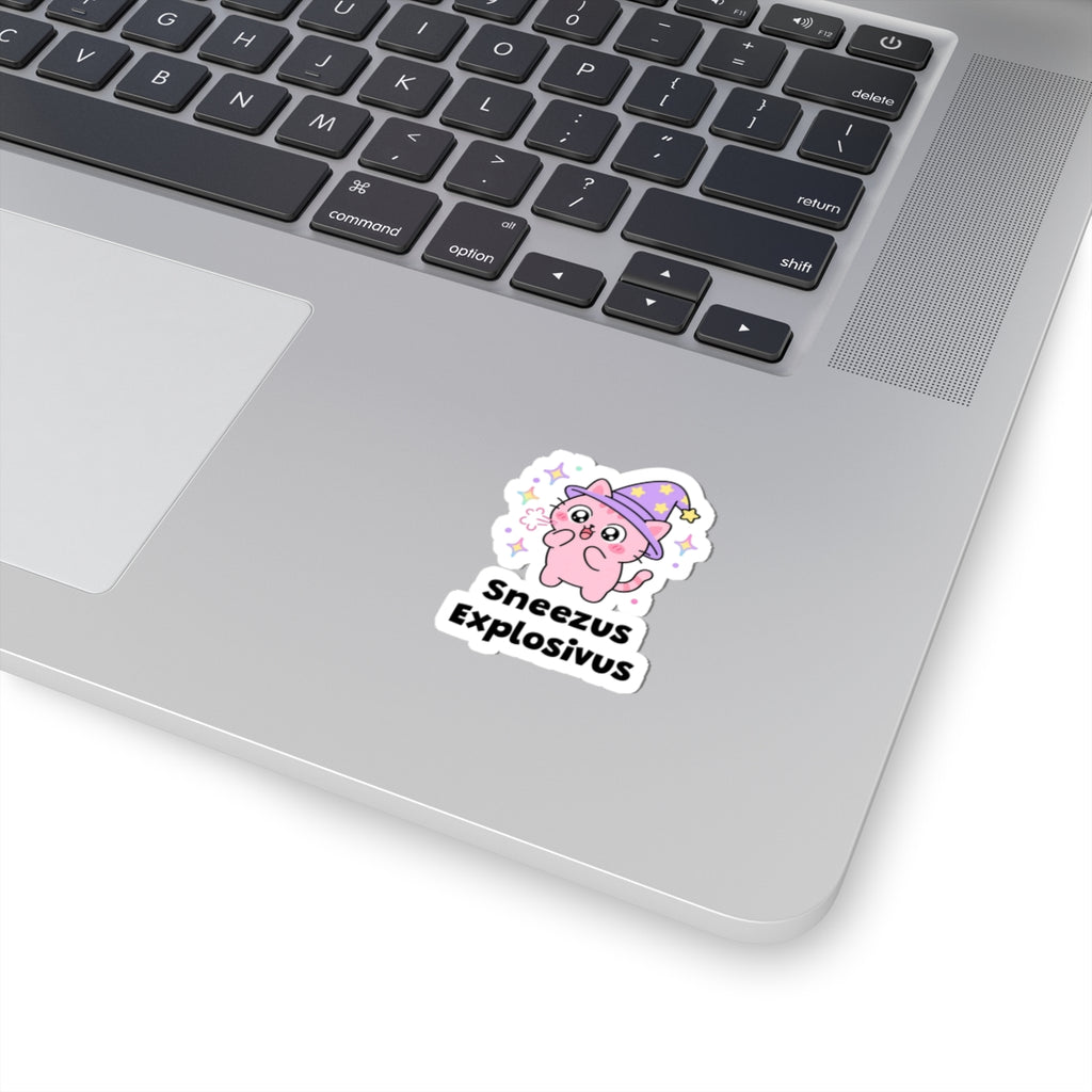 Sneezus Explosivus wizard cat sticker stuck on a silver laptop next to the keyboard