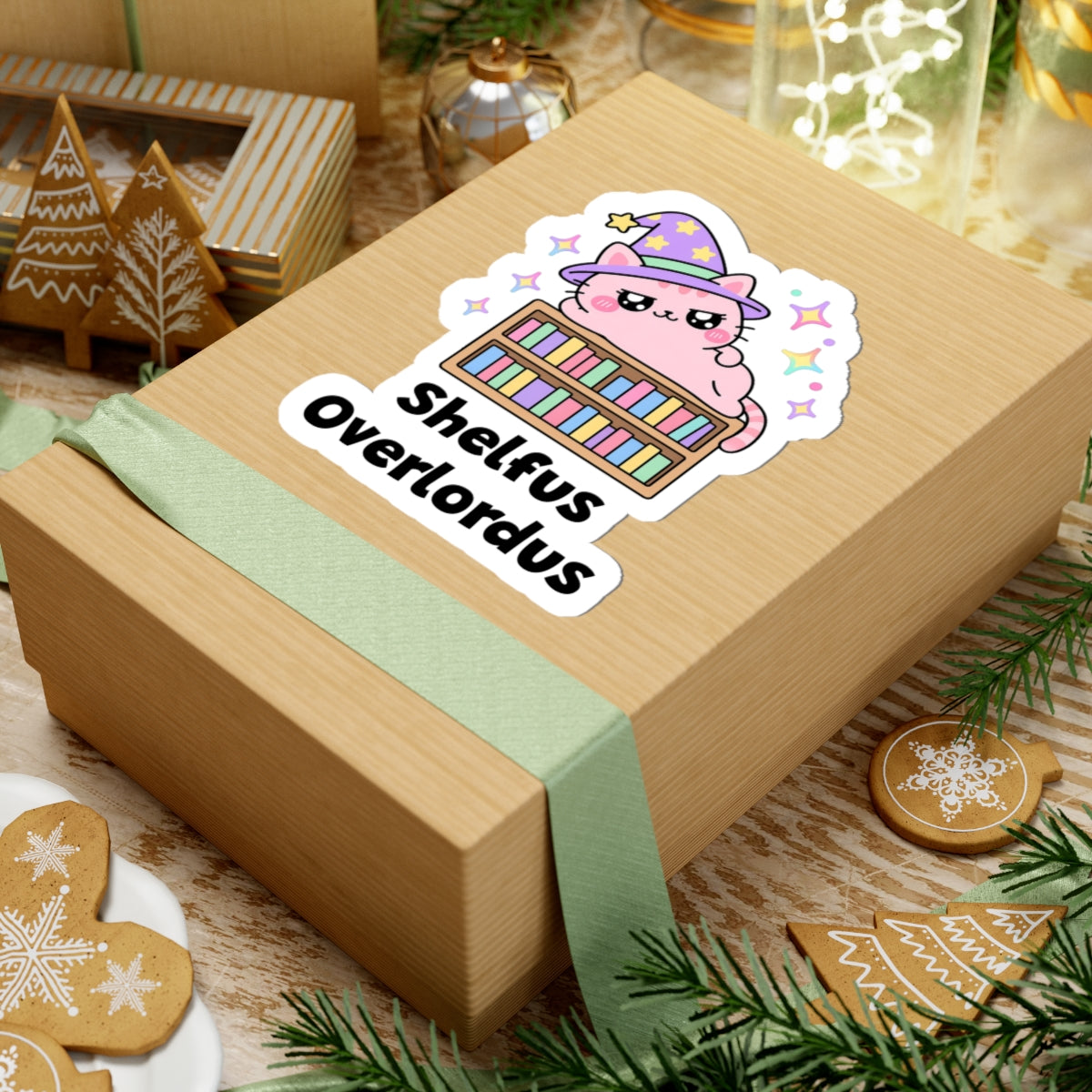 Shelfus Overlordus wizard cat sticker on a kraft gift box with a green ribbon and holiday cookies