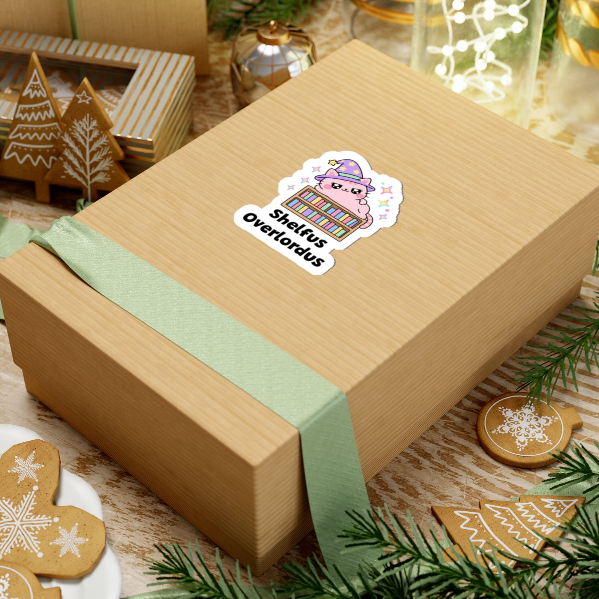 Shelfus Overlordus wizard cat sticker on a kraft gift box with a green ribbon and holiday cookies