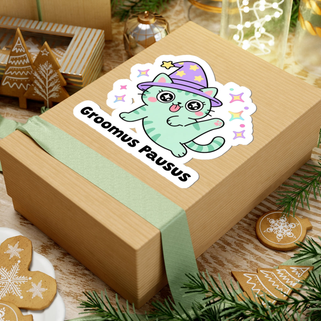 Groomus Pausus wizard cat sticker on a kraft gift box with a green ribbon and holiday cookies