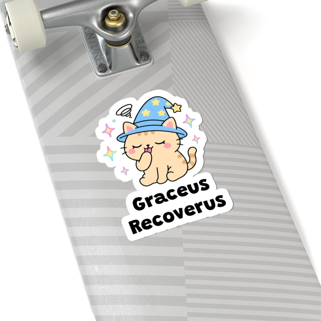Graceus Recoverus wizard cat sticker on a grey skateboard deck near the truck