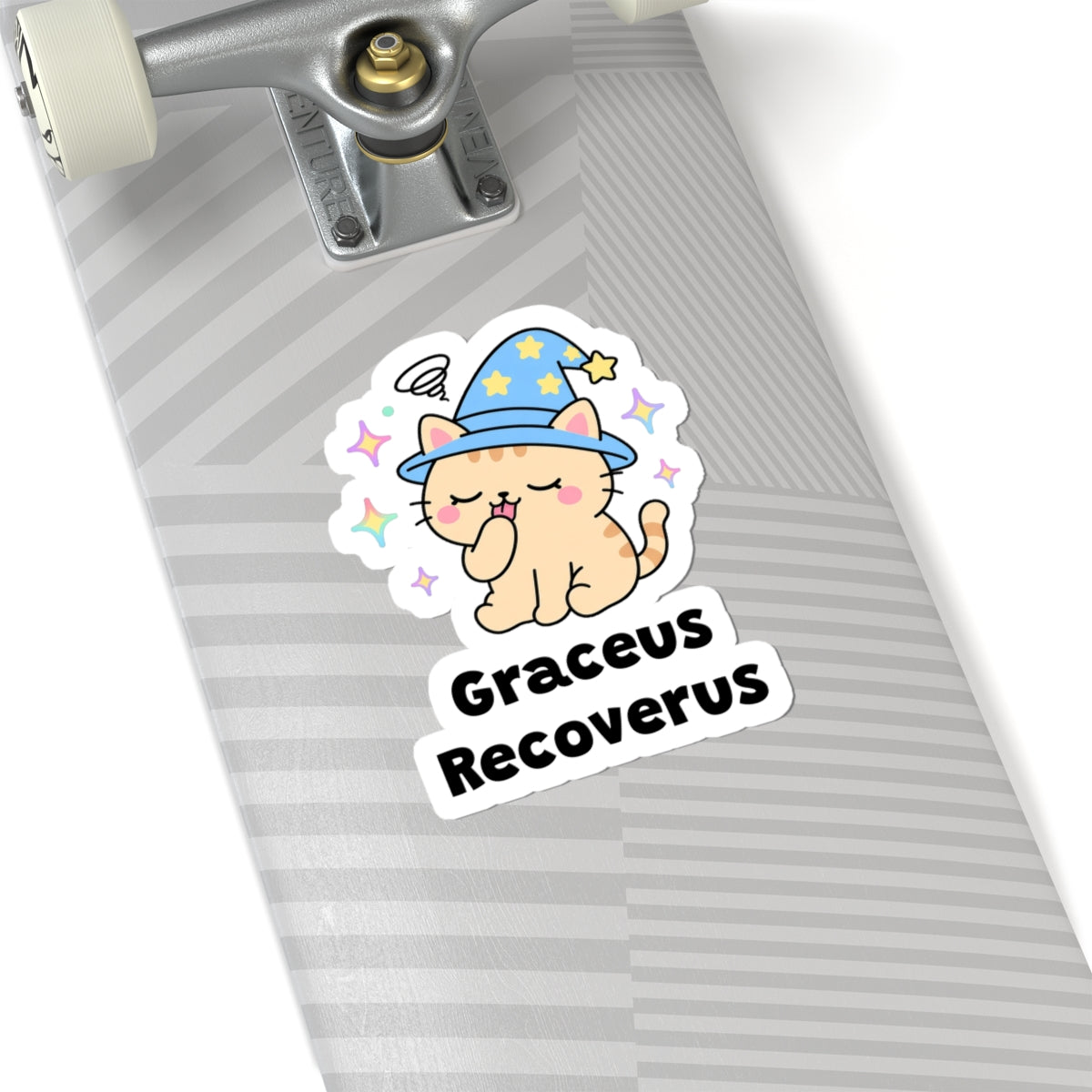 Graceus Recoverus wizard cat sticker on a grey skateboard deck near the truck