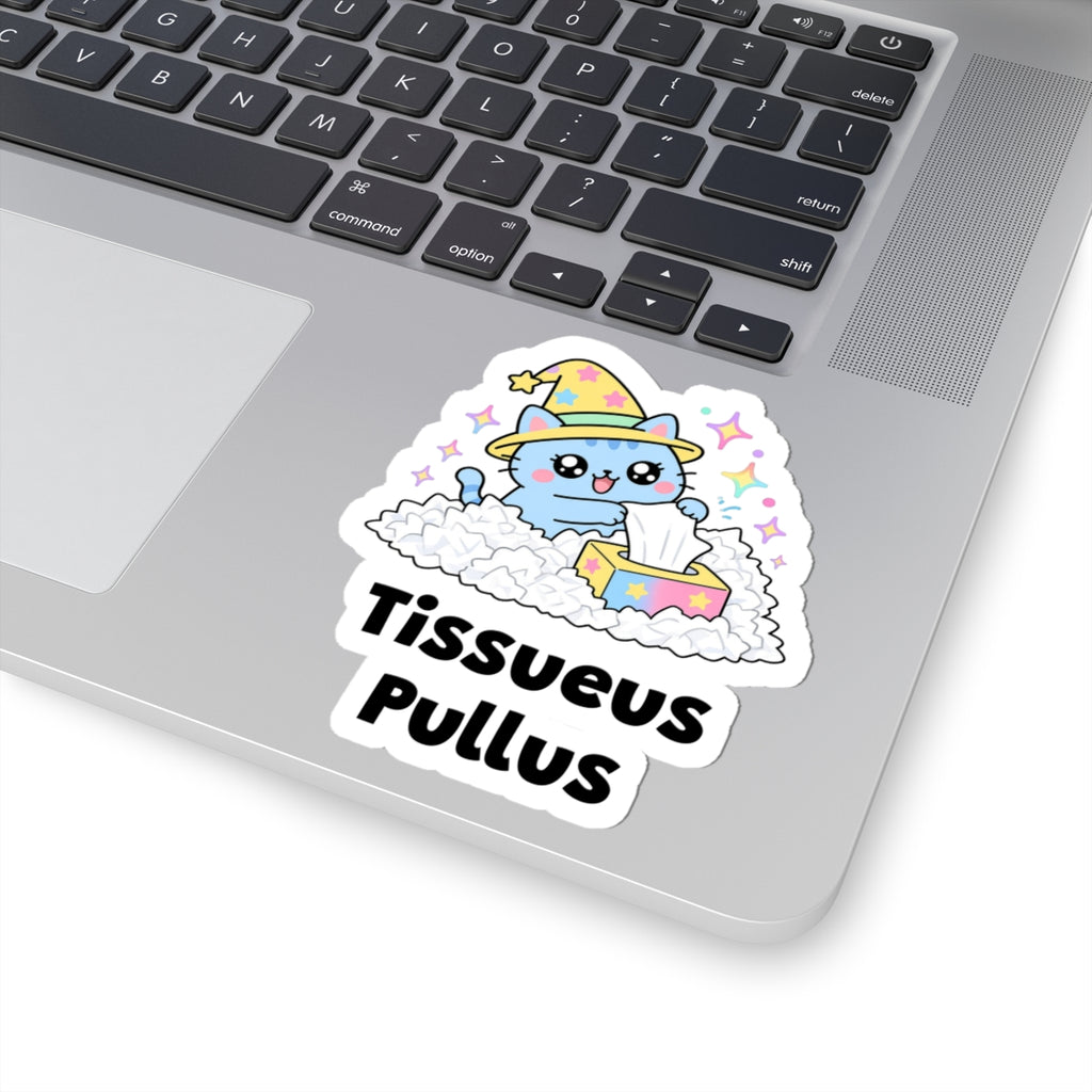 Tissueus Pullus wizard cat sticker stuck on a silver laptop next to the keyboard