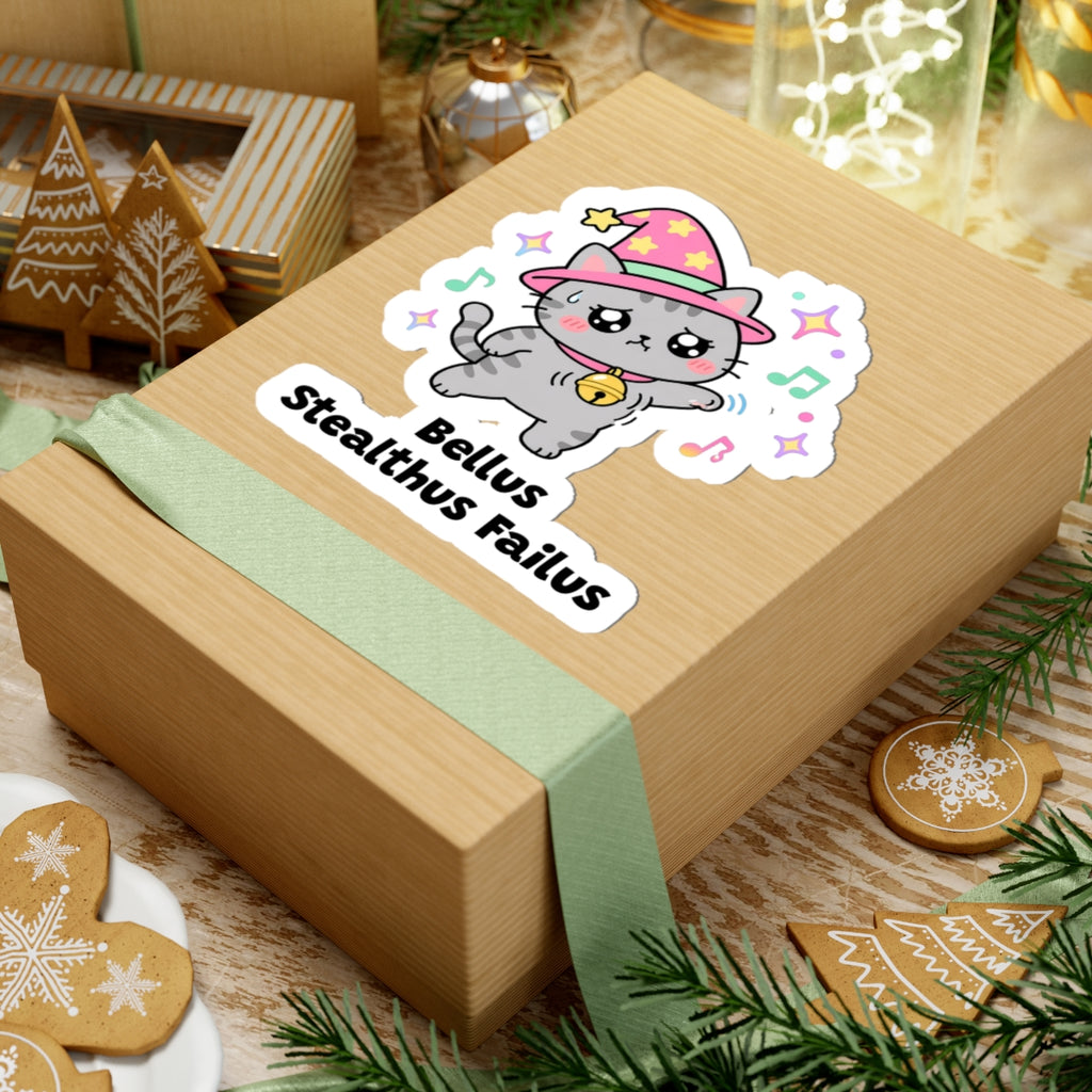 Bellus Stealthus Failus wizard cat sticker on a kraft gift box with a green ribbon and holiday cookies
