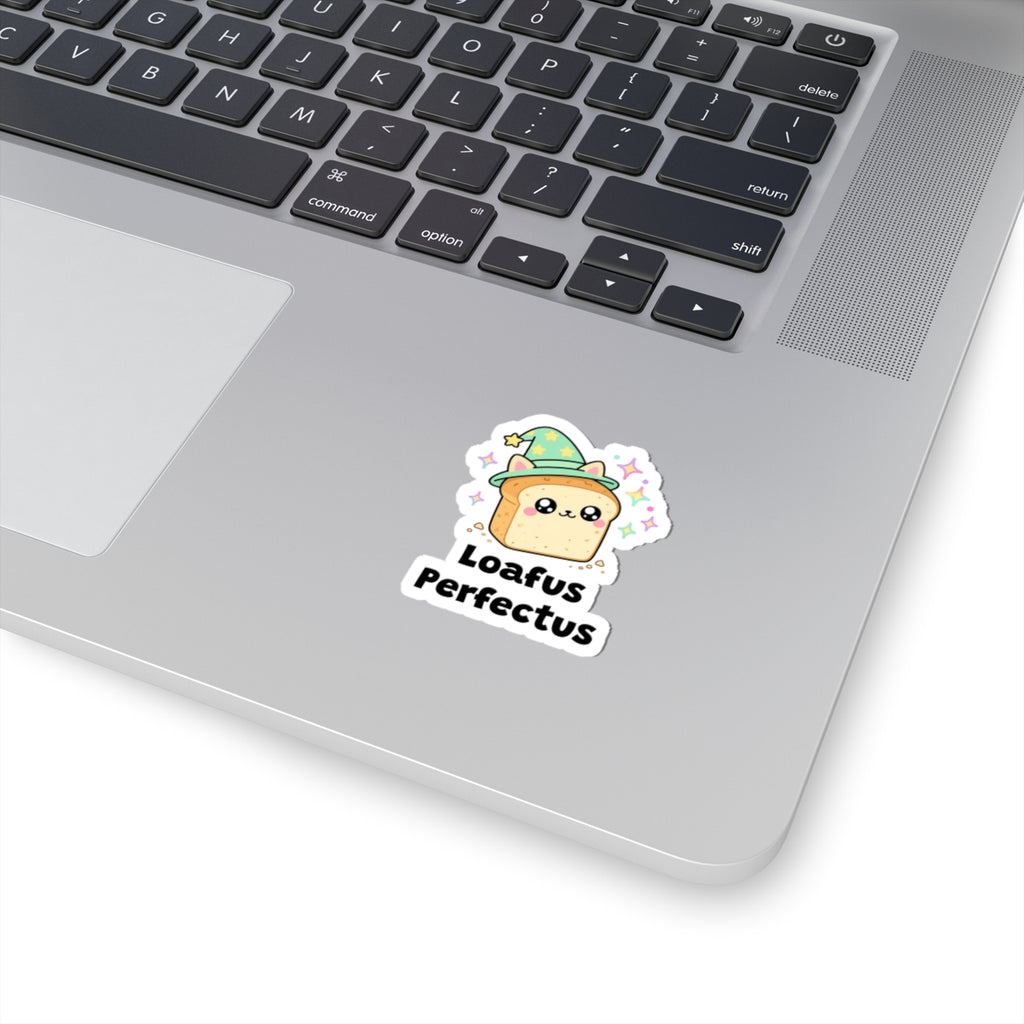 Loafus Perfectus wizard cat sticker stuck on a silver laptop next to the keyboard