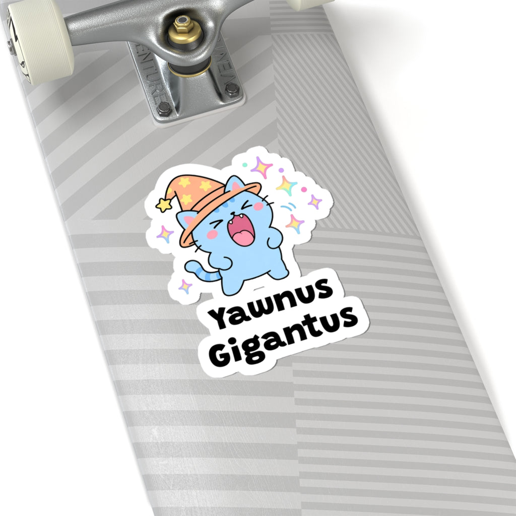Yawnus Gigantus wizard cat sticker on a grey skateboard deck near the truck